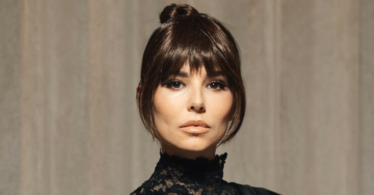 Cheryl Tweedy posing for the camera, wearing a turtle neck