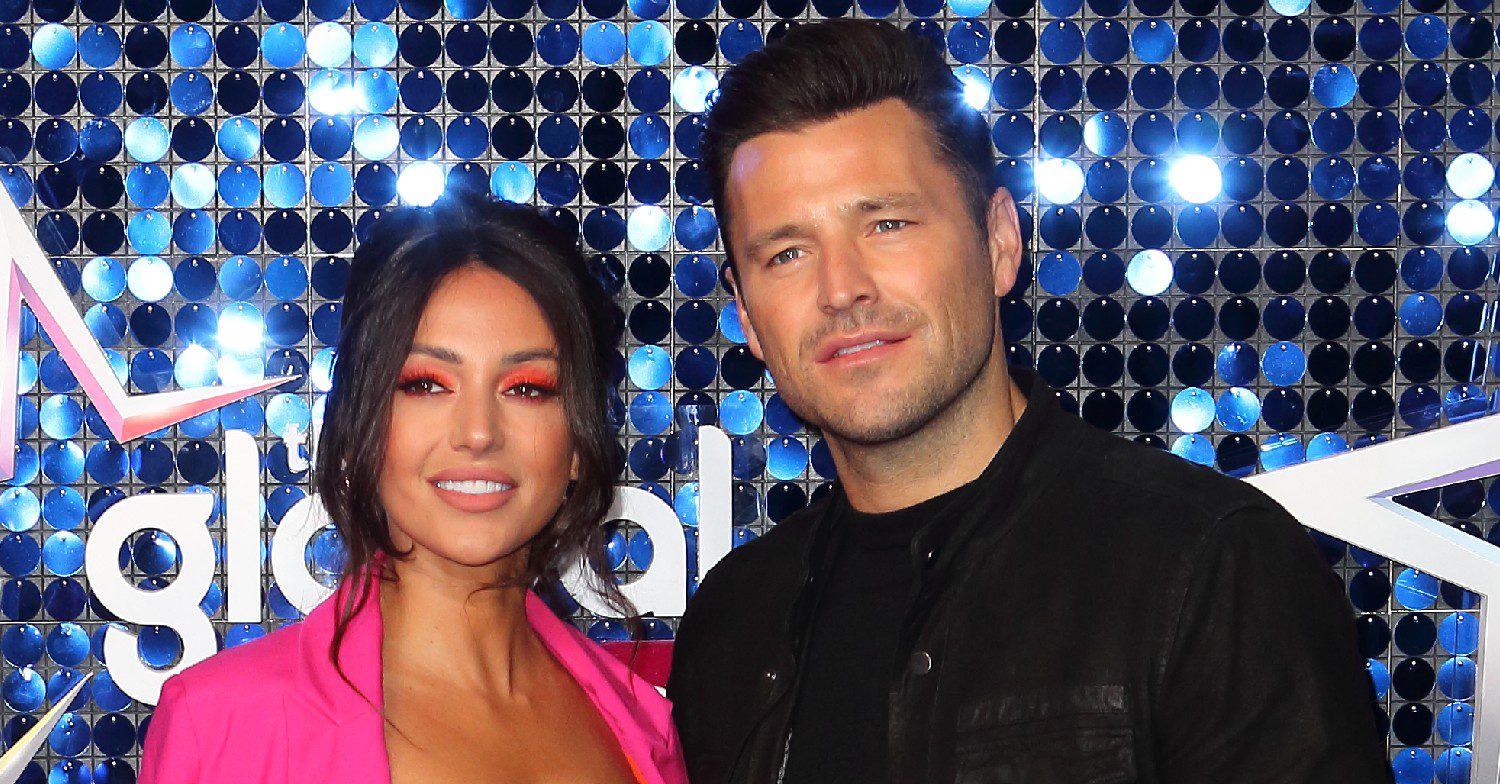 Michelle Keegan and Mark Wright smiling at a red carpet event