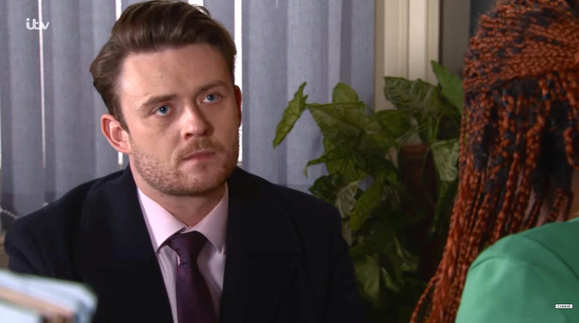 Joel in Coronation Street looks serious