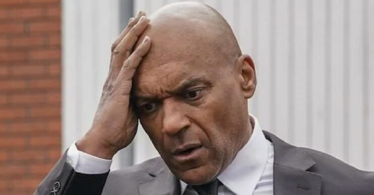 EastEnders comp image: George Knight grabs his head looking worried