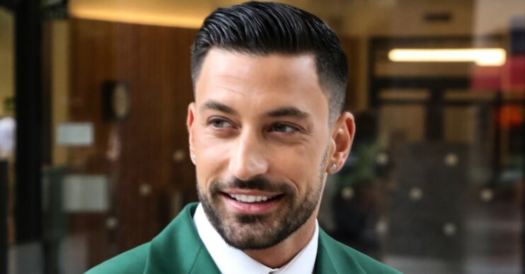 Giovanni Pernice smiling in a green suit