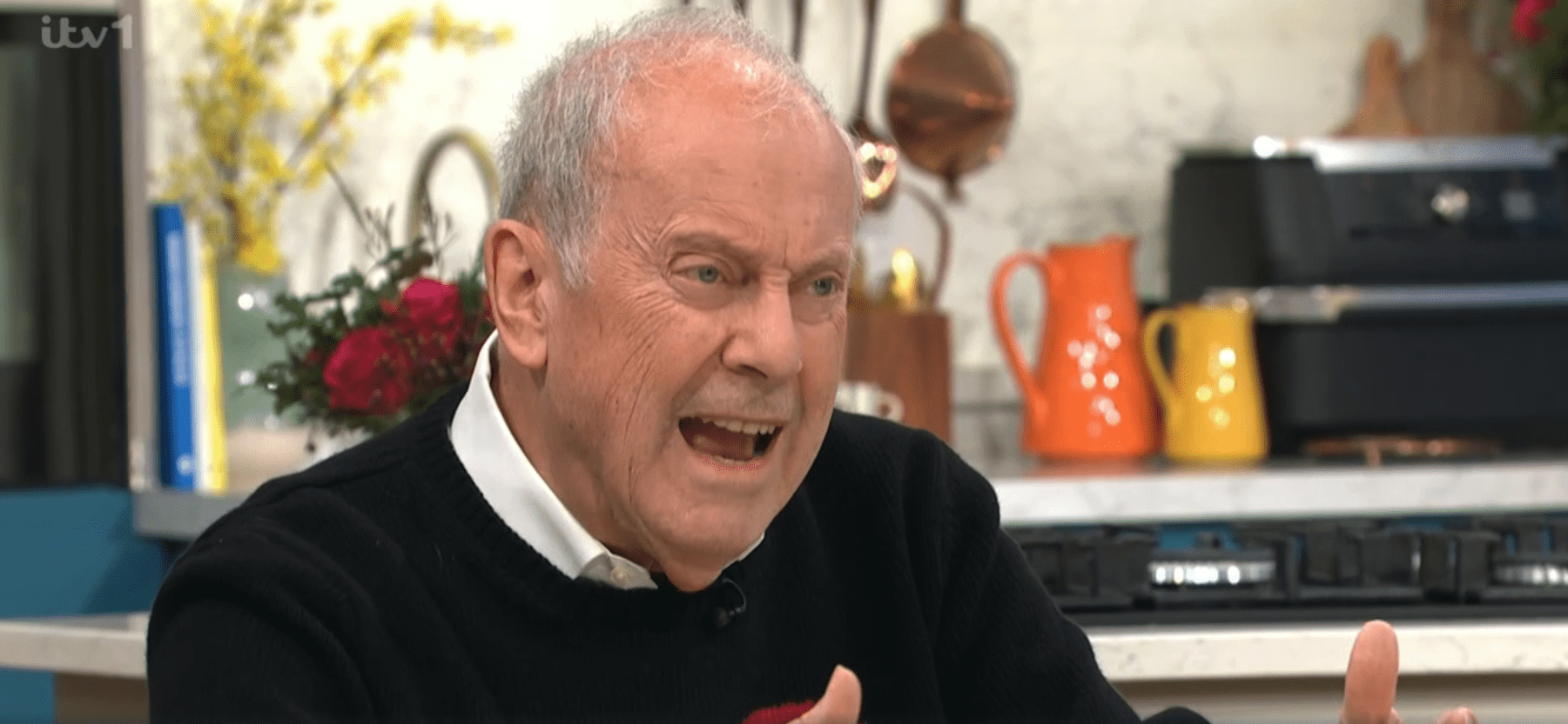 Gyles Brandreth looking angry on This Morning in black jumper