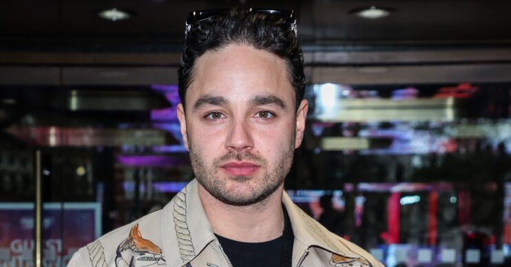 Adam Thomas looks serious at event