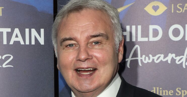 Eamonn Holmes smiling on the red carpet wearing a suit