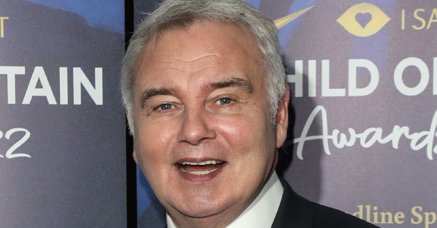 Eamonn Holmes smiling on the red carpet wearing a suit