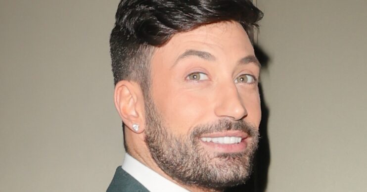 Giovanni Pernice smiling in a green suit