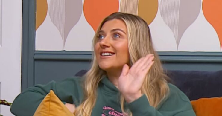 Izzi Warner with her hand up on Gogglebox