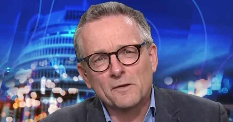 Dr Michael Mosley in a blue suit speaking on television