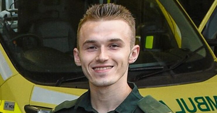 Dan Duffield smiling in front of an ambulance