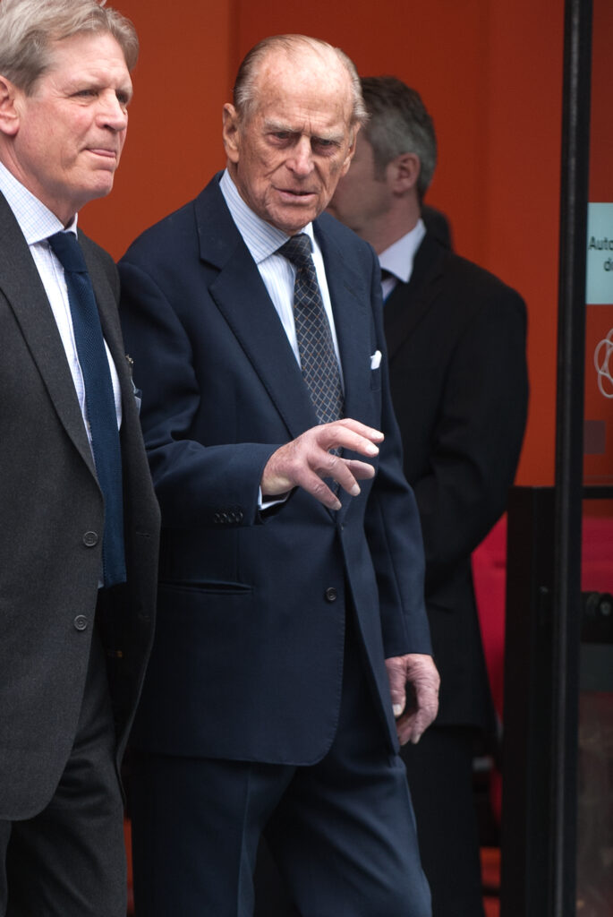 Prince Philip wears a dark navy suit
