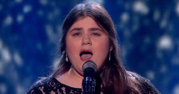 Britain's got Talent star Emma Jones singing into microphone wearing pink lipstick