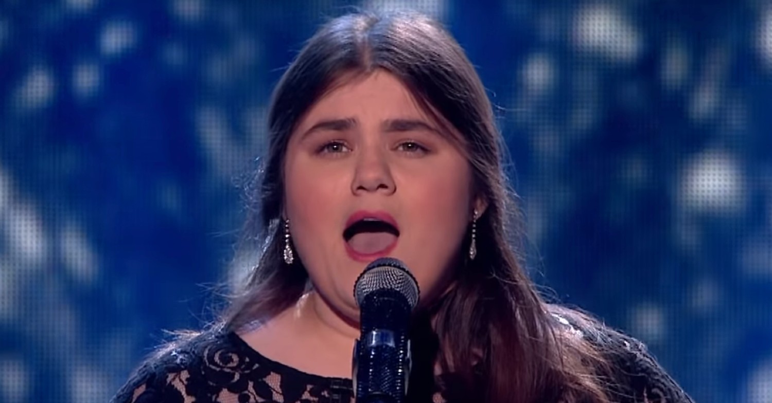Britain's got Talent star Emma Jones singing into microphone wearing pink lipstick
