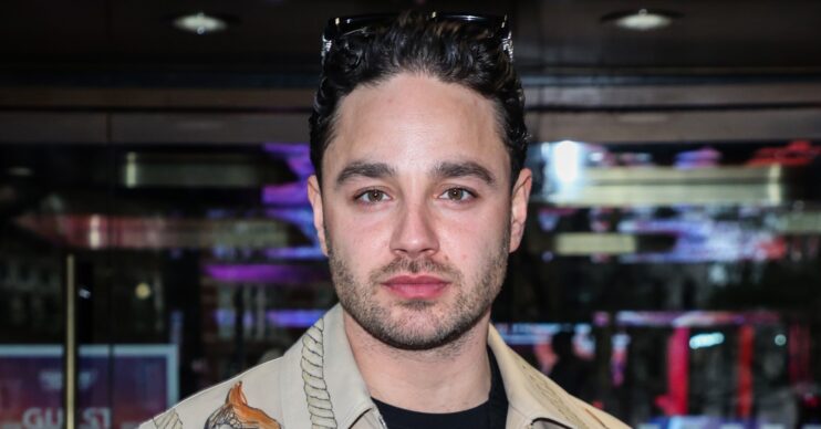 Adam Thomas looking at camera at event