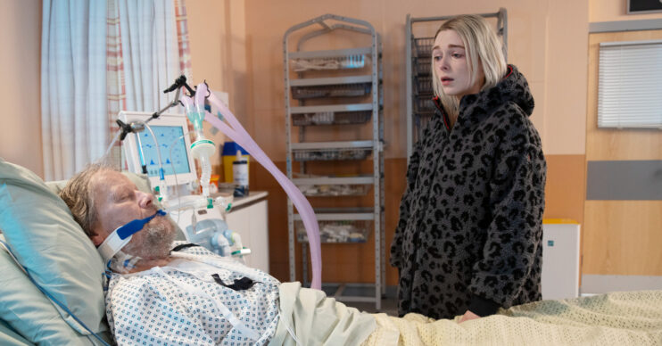 Coronation Street's Lauren is standing next to Roy's hospital bedside