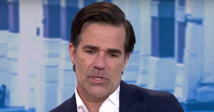 Rob Delaney looks downwards