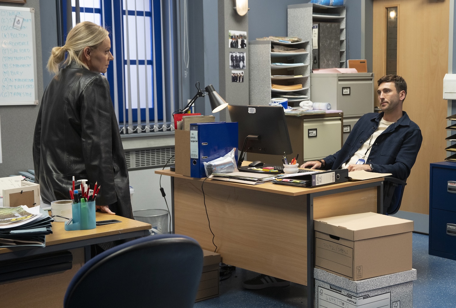 Corrie's Kit and Swain are talking in the police station office