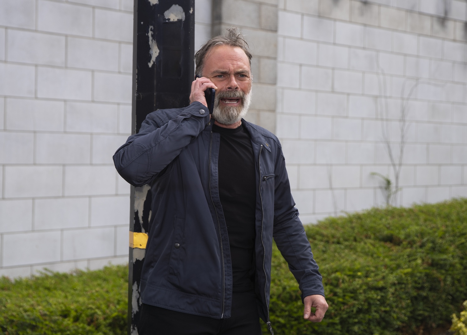 Billy looks panicked on the phone on Corrie