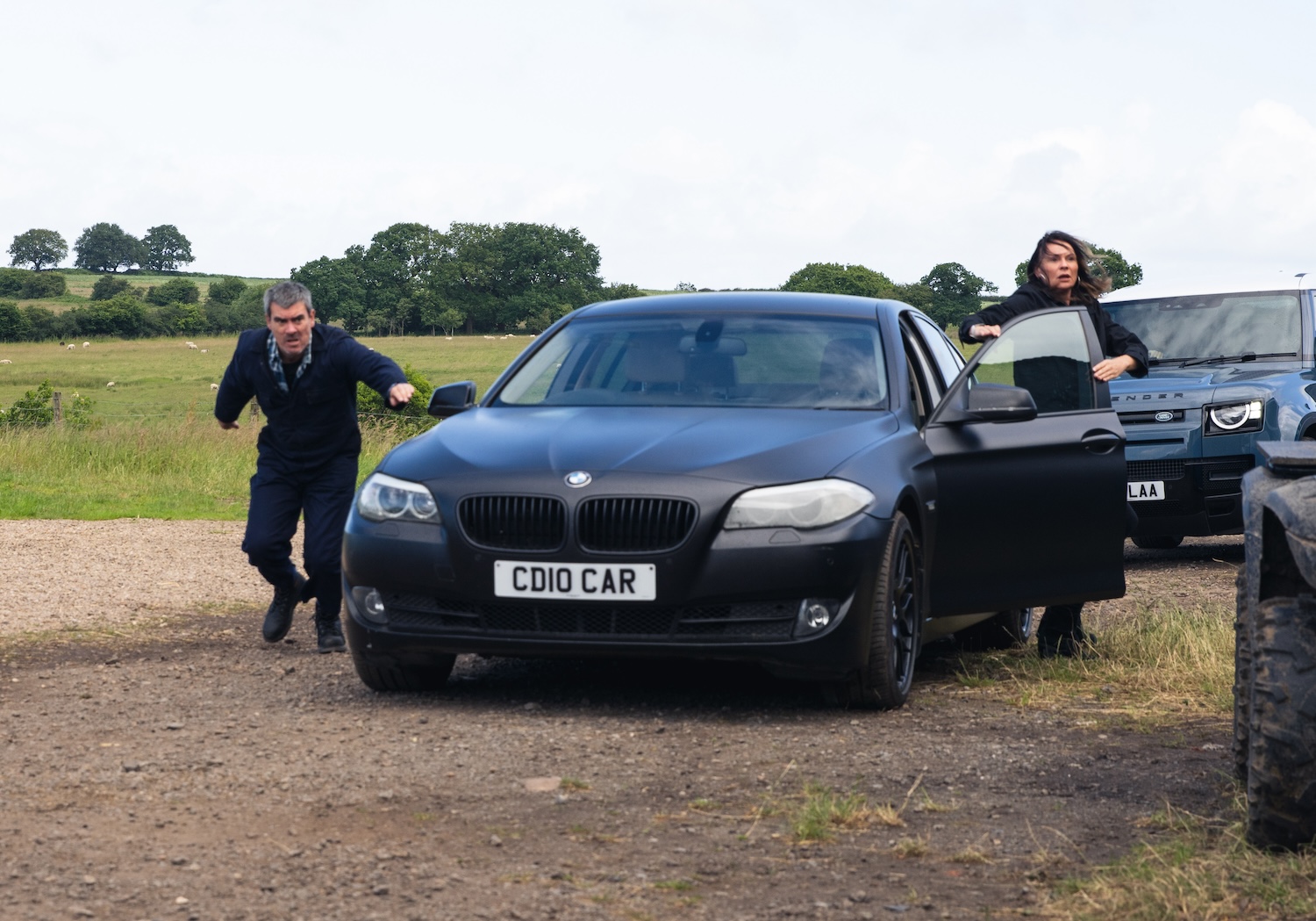 Cain and Chas look panicked as they get out of a car on Emmerdale