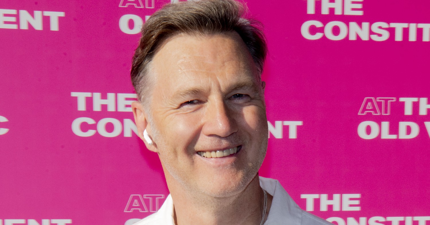 David Morrissey against a pink background
