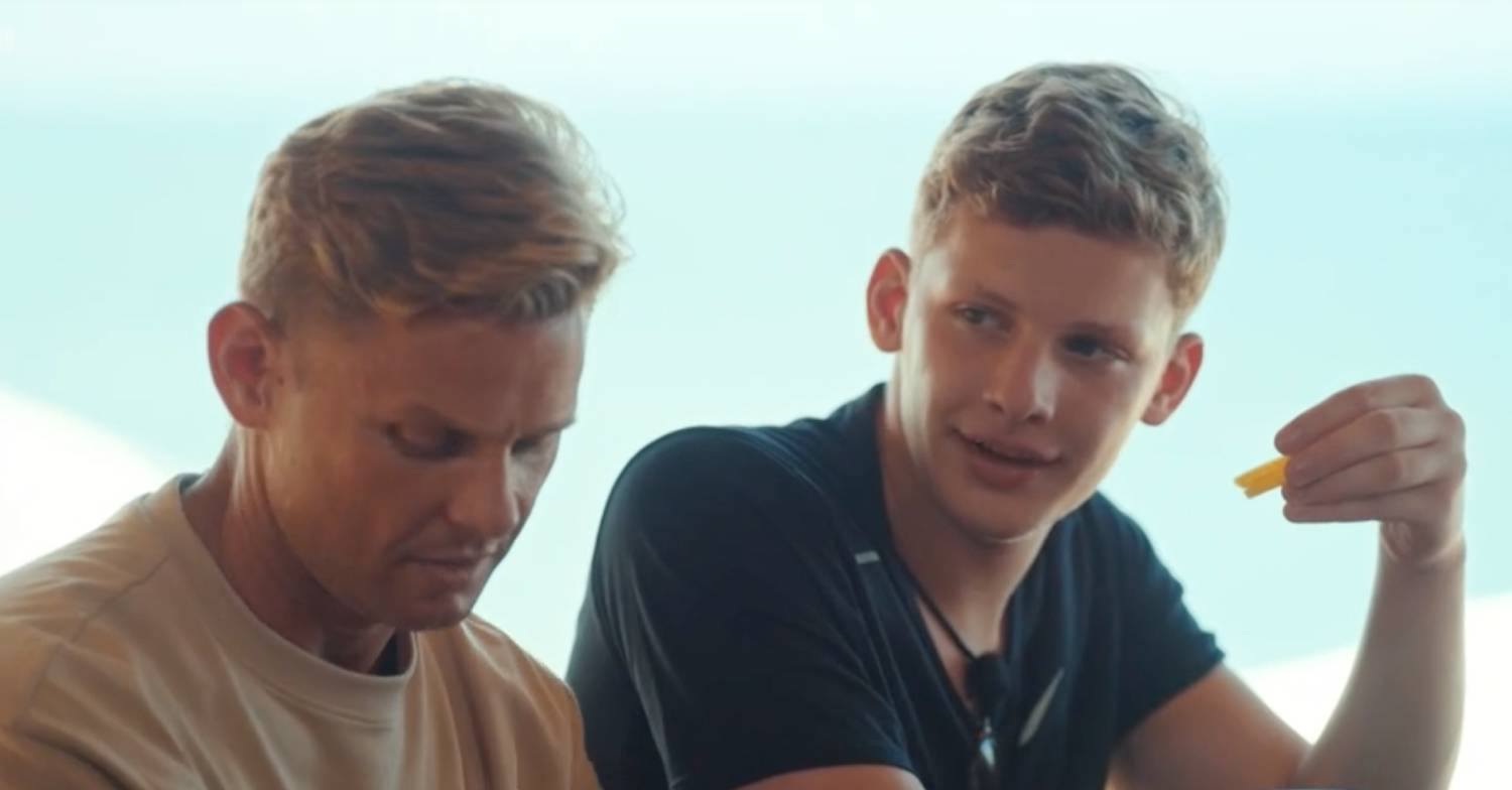Jeff Brazier looks down, Freddie Brazier holds a chip