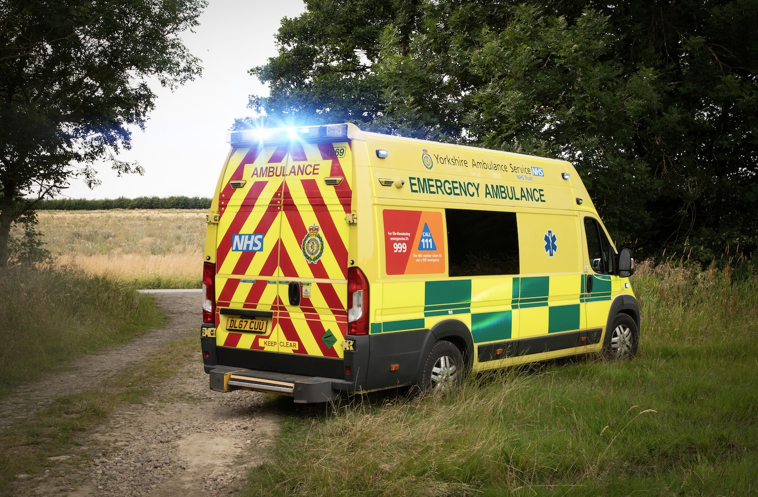 An ambulance is in a field