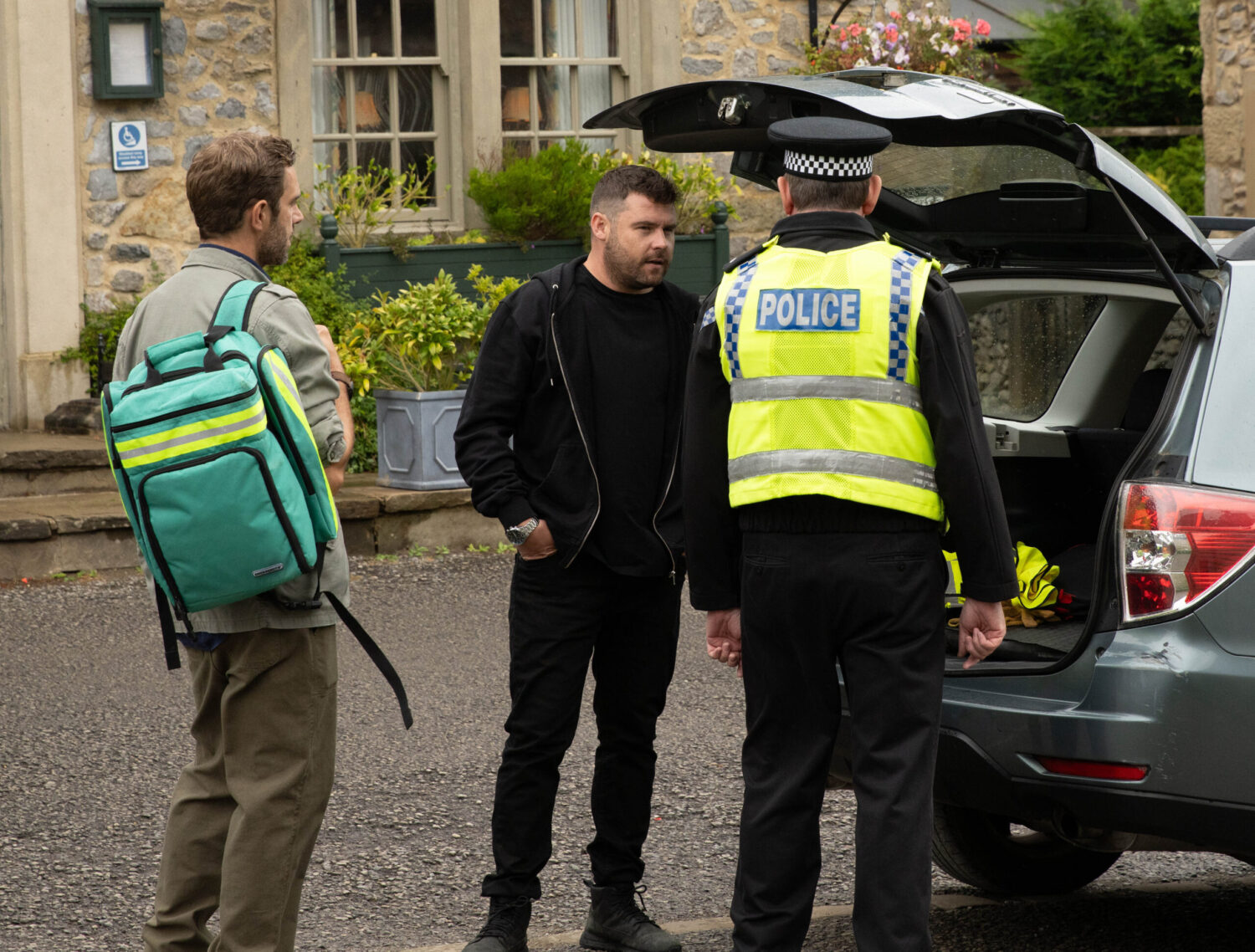 John, PC Swirling and Aaron are at the boot of the car