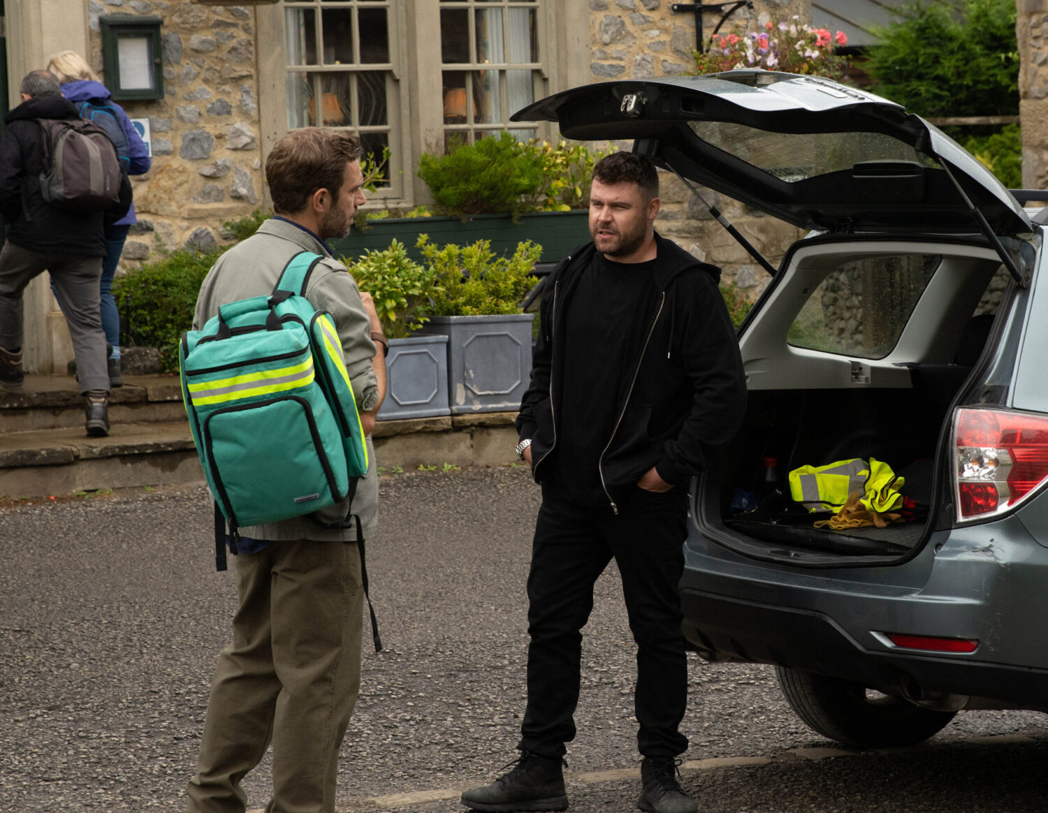John and Aaron are at the boot of the car