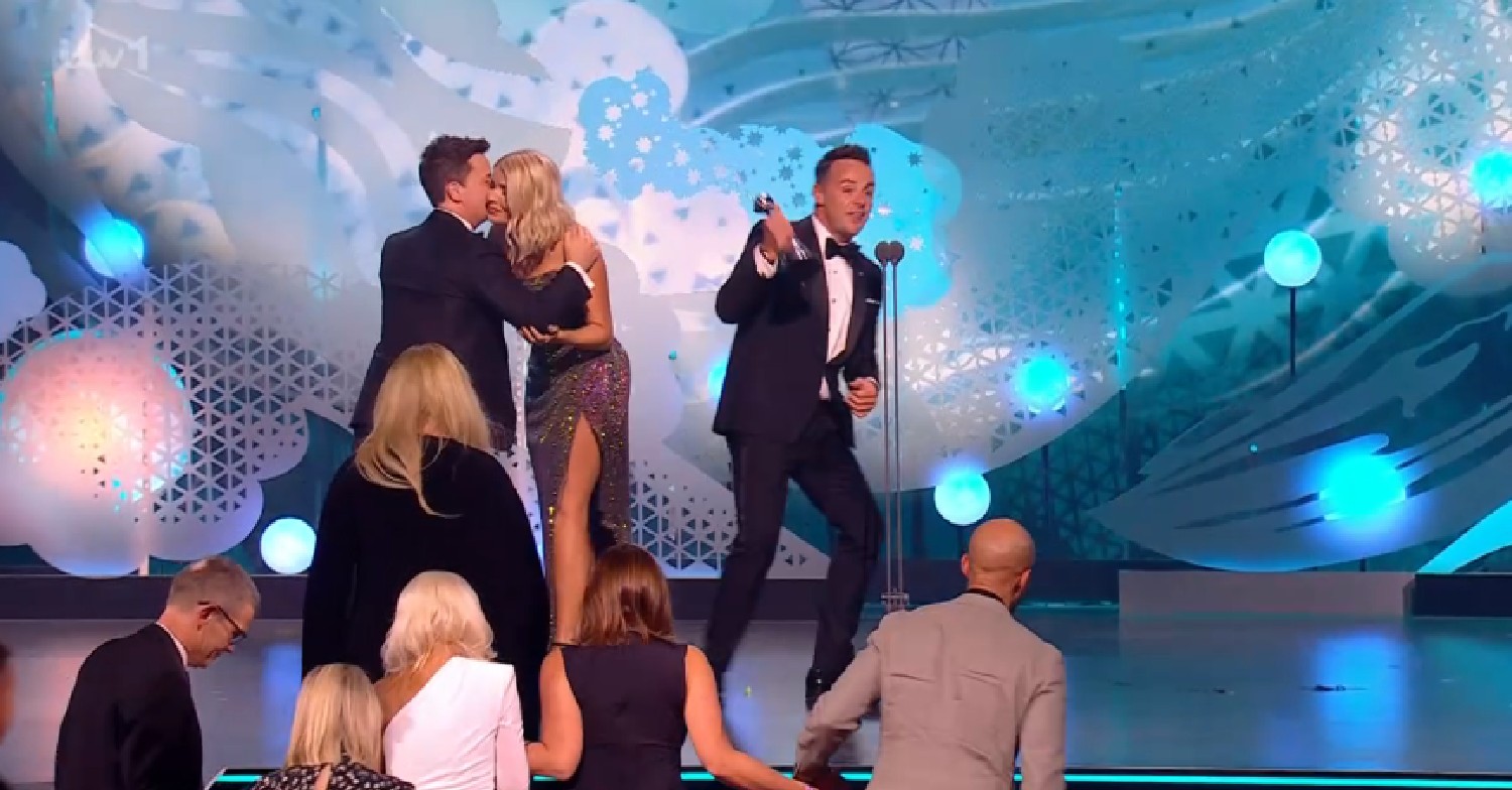 Holly Willoughby kissing Ant and Dec on stage at NTAs