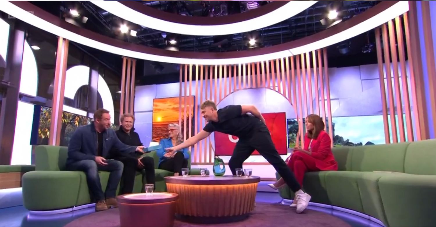 Roman Kemp handing over a tissue to Russell Watson