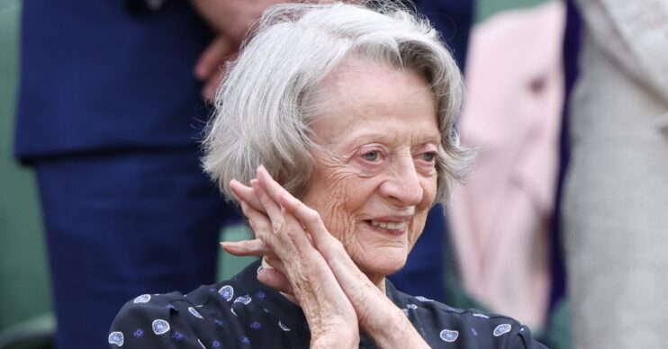 Dame Maggie Smith at Wimbledon clasping her hands together and smiling