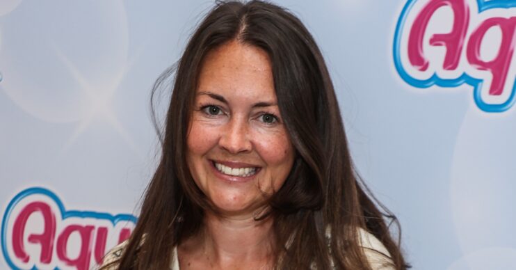 Lacey Turner smiling with long brown hair