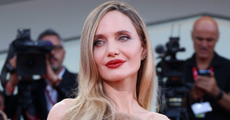 Angelina Jolie close-up wearing a shawl and a nude dress as Venice film festival