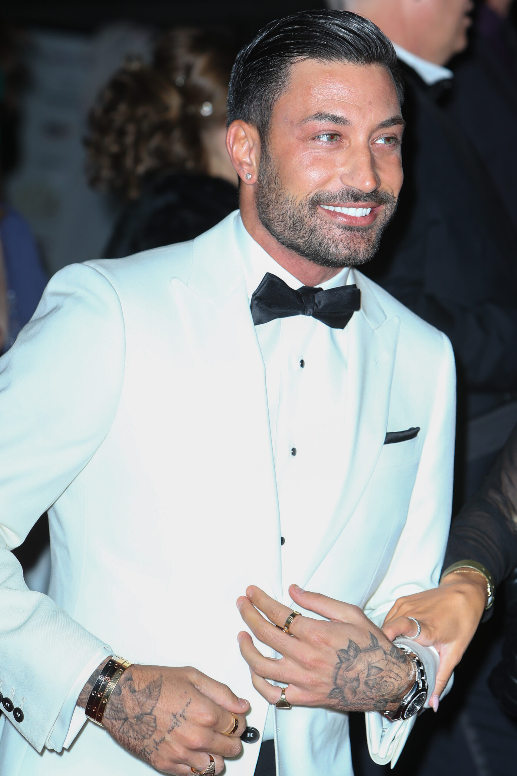 Giovanni Pernice smiling in white suit jacket
