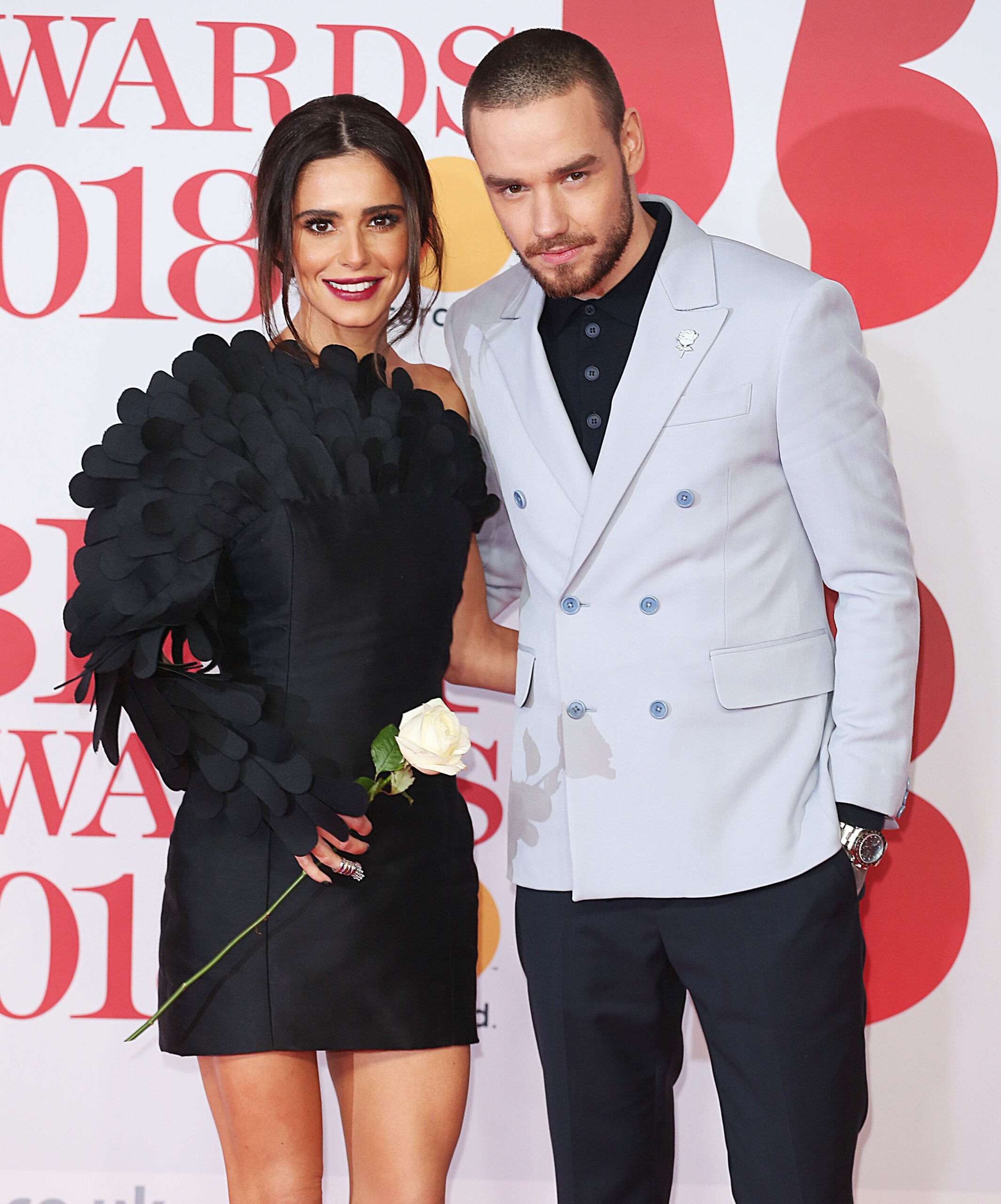 Liam and Cheryl on a red carpet posing