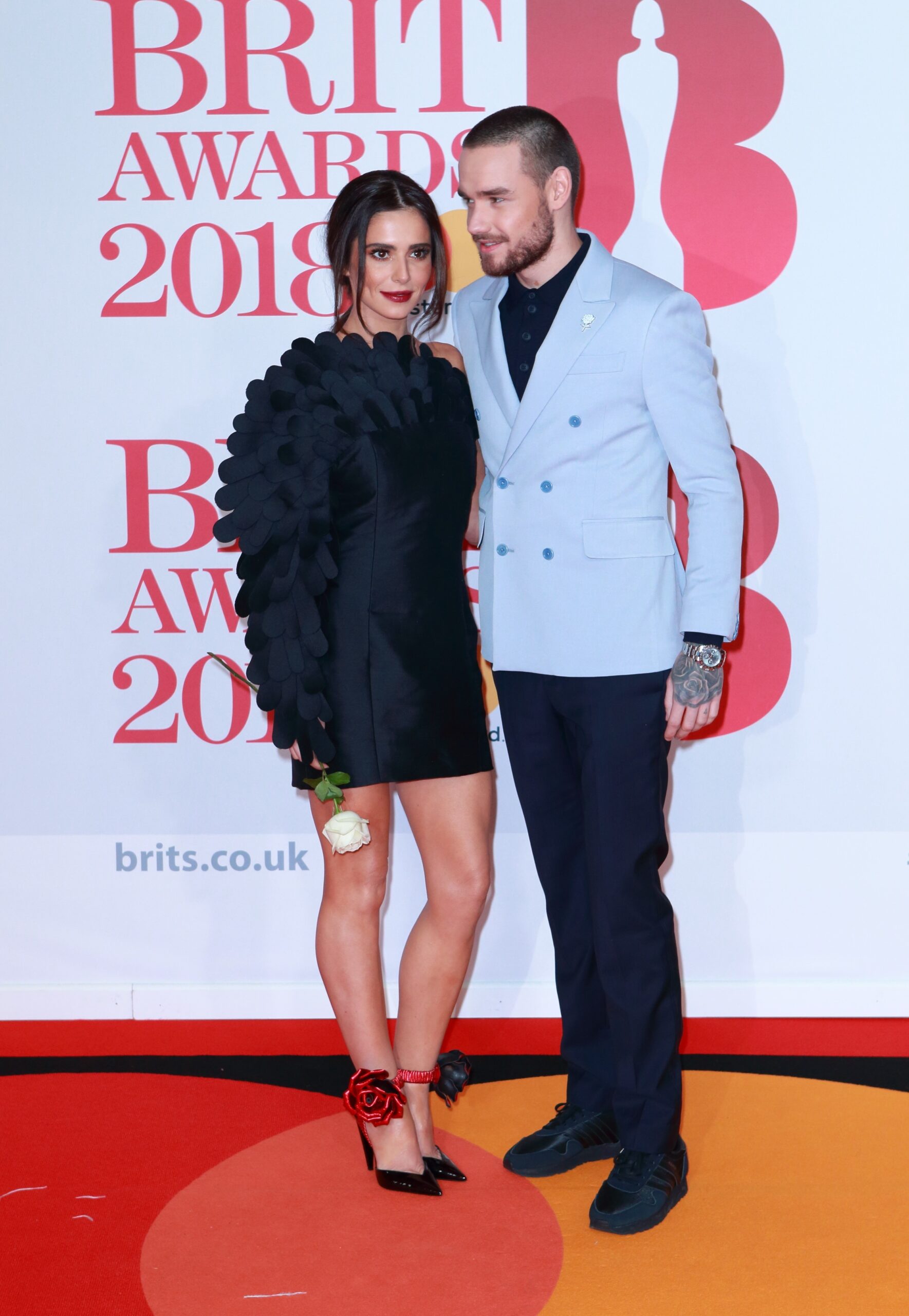 Cheryl and Liam Payne posing on red carpet at the BRITs