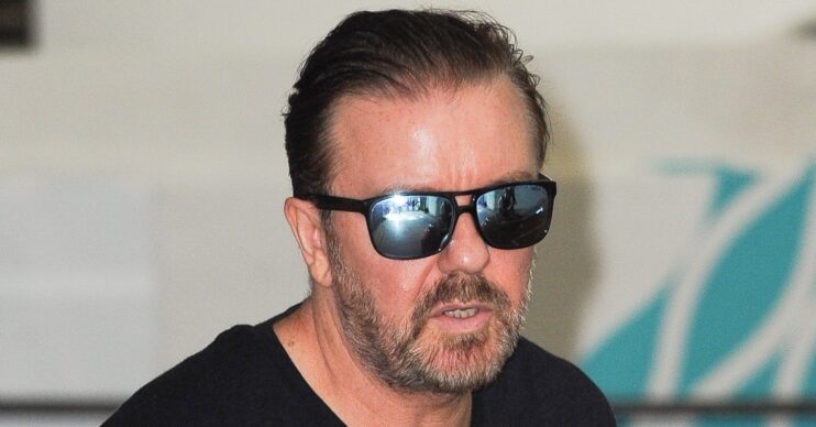 Ricky Gervais frowning wearing sunglasses