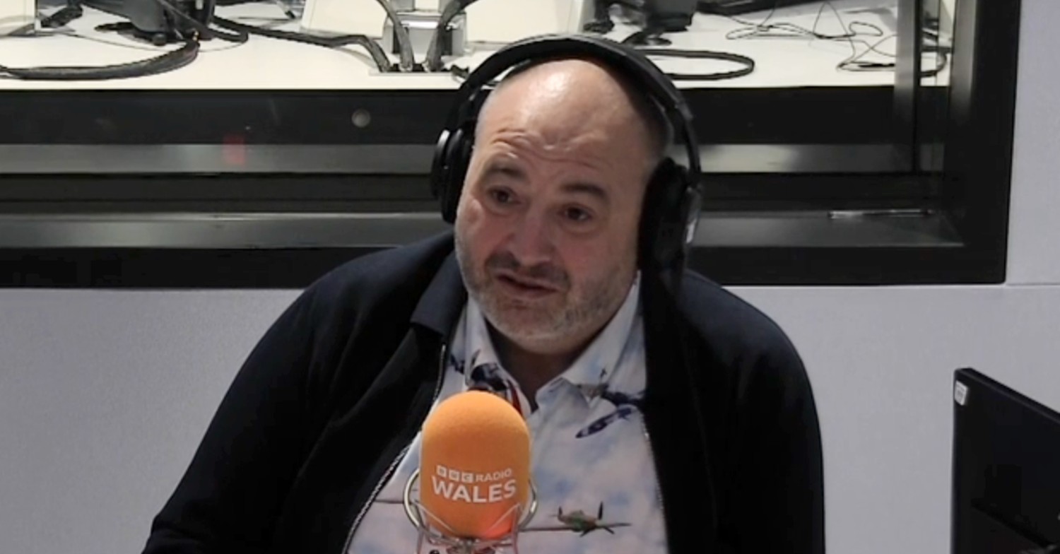 Strictly star Wynne Evans wearing headphones on radio