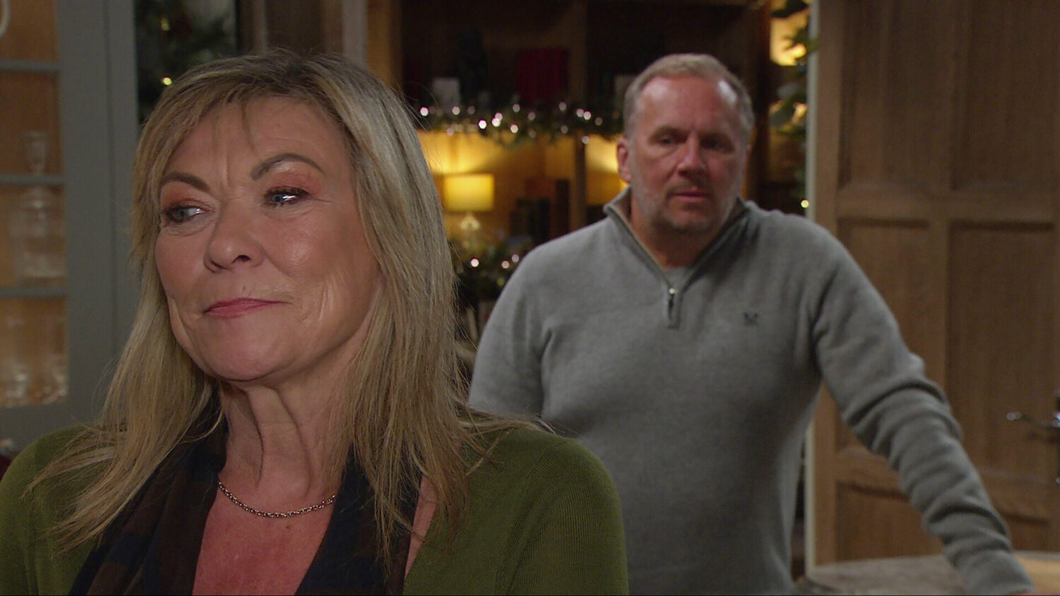 Kim smiling with back turned to Will on Emmerdale