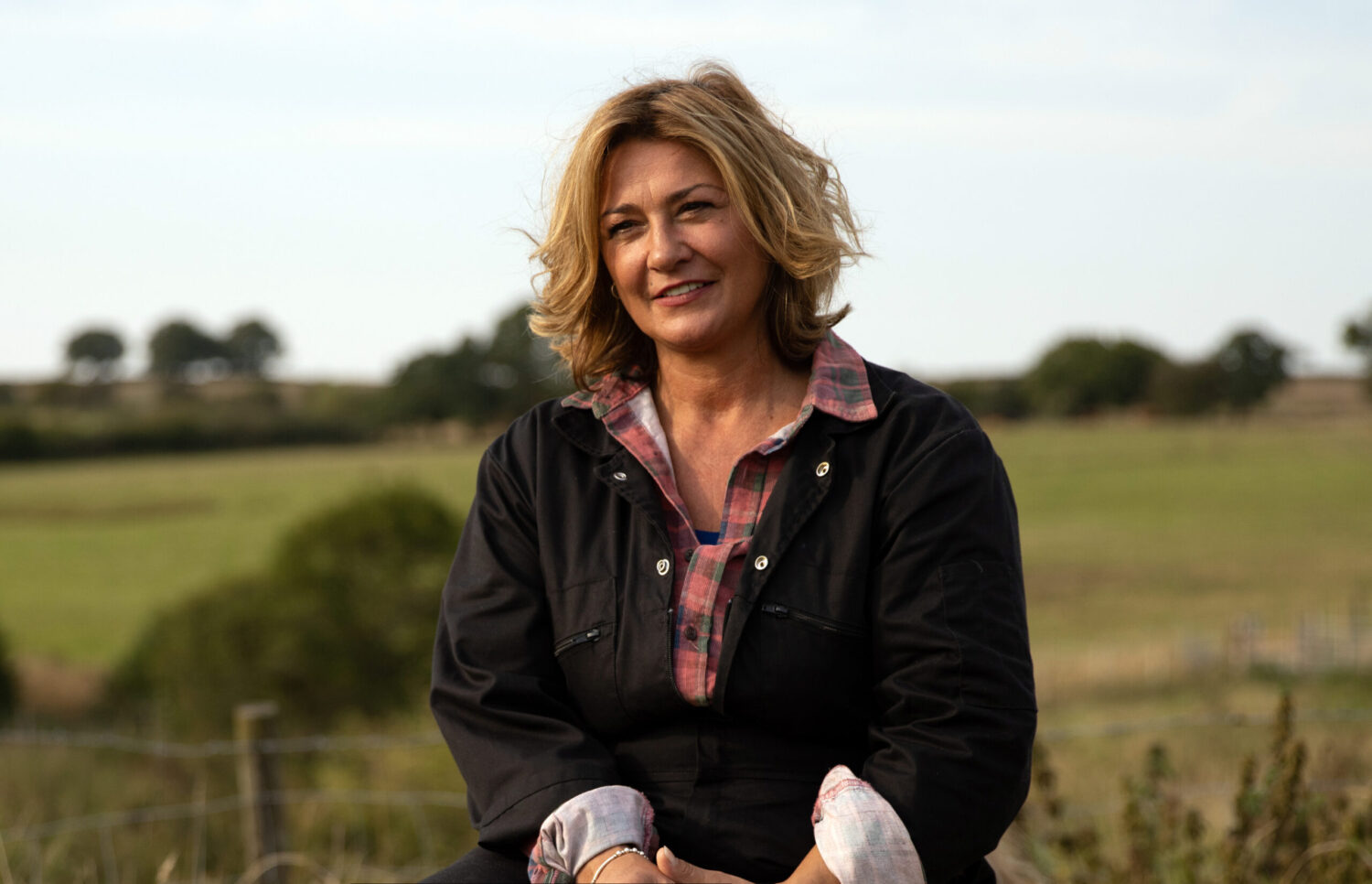 Moira is smiling on the farm in Emmerdale