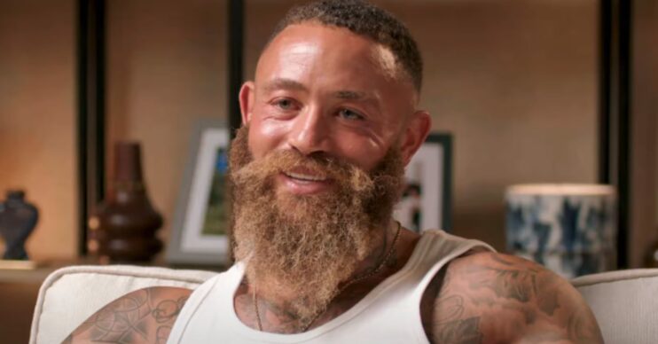 Ashley Cain smiling in podcast interview