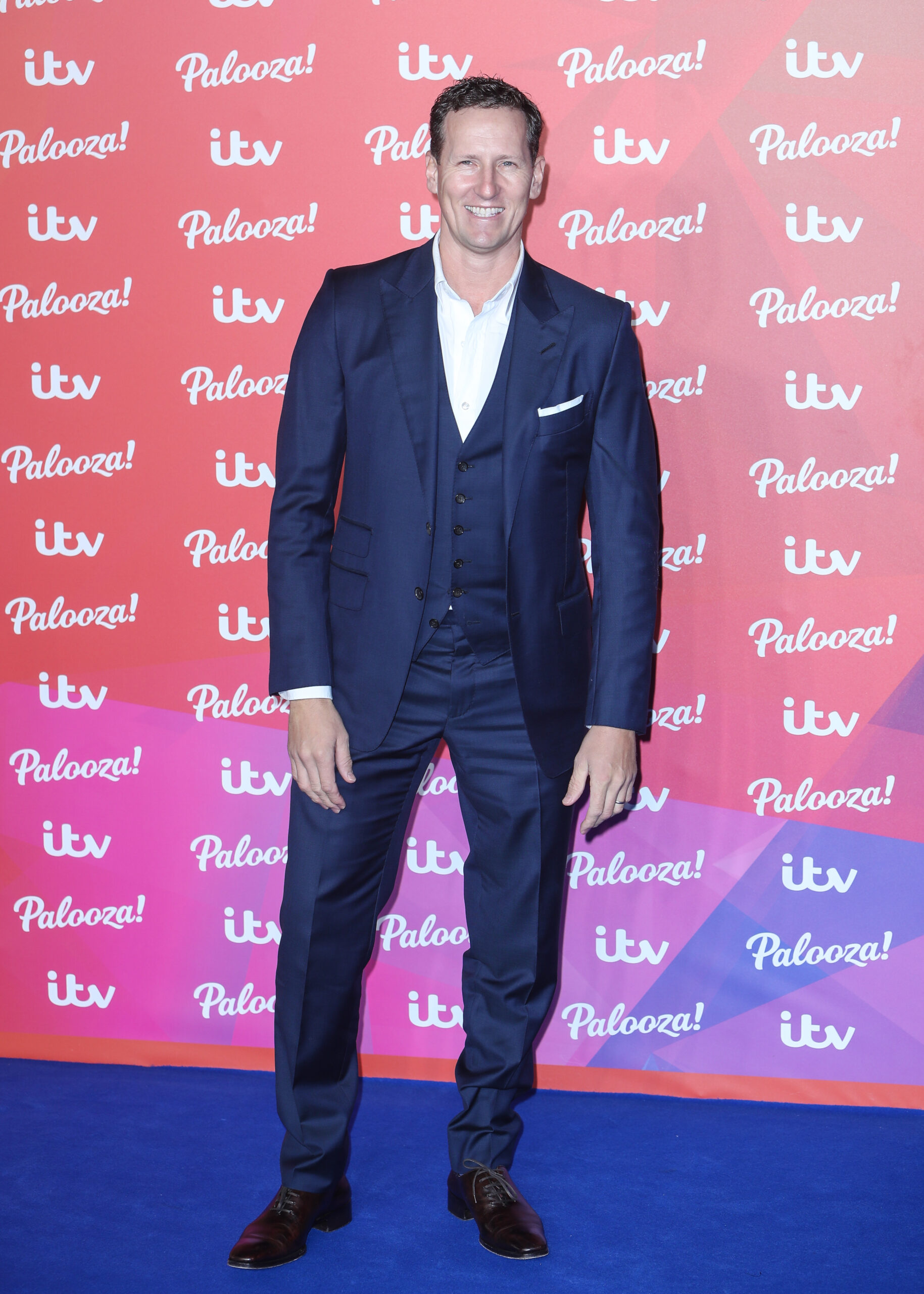 Brendan Cole smiling in blue suit at ITV Palooza