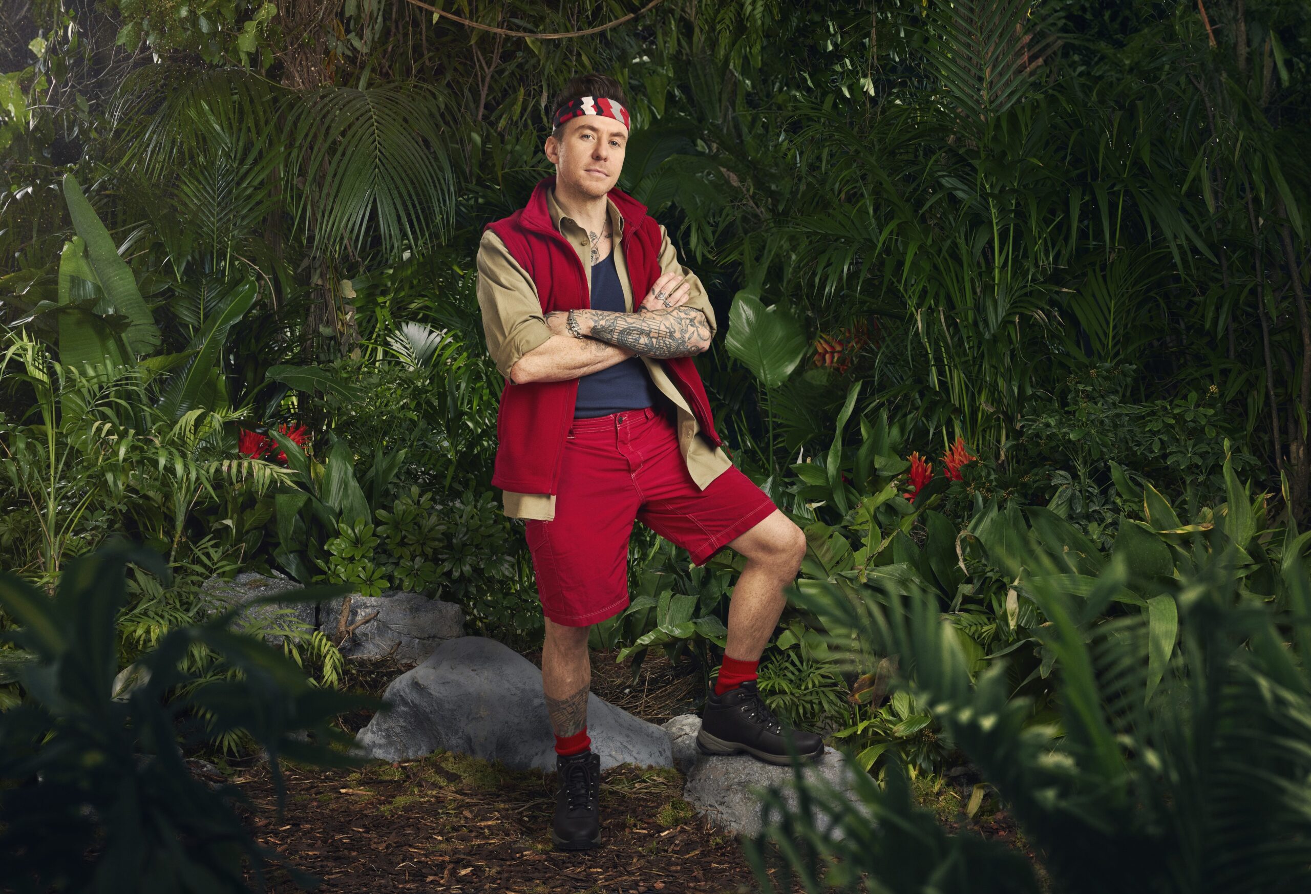 Danny Jones with his arms crossed in I'm A Celebrity 2024 official pic