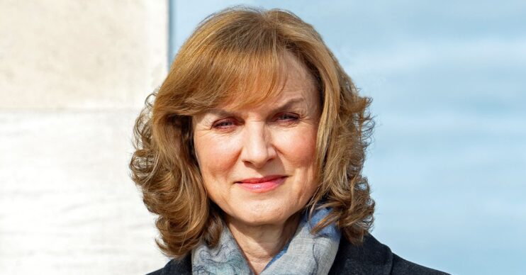 Fiona Bruce looking to camera in a scarf