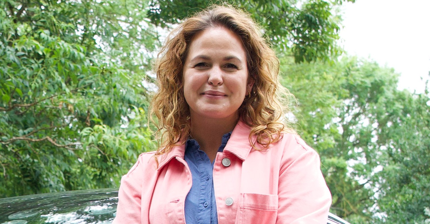 Giovanna Fletcher wearing a pink jacket smiling