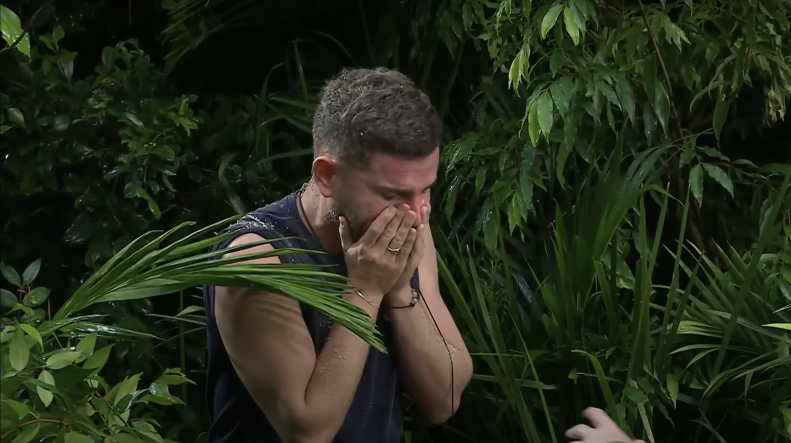 Dean McCullough rubs his face after cancelling his trial early on I'm A Celebrity
