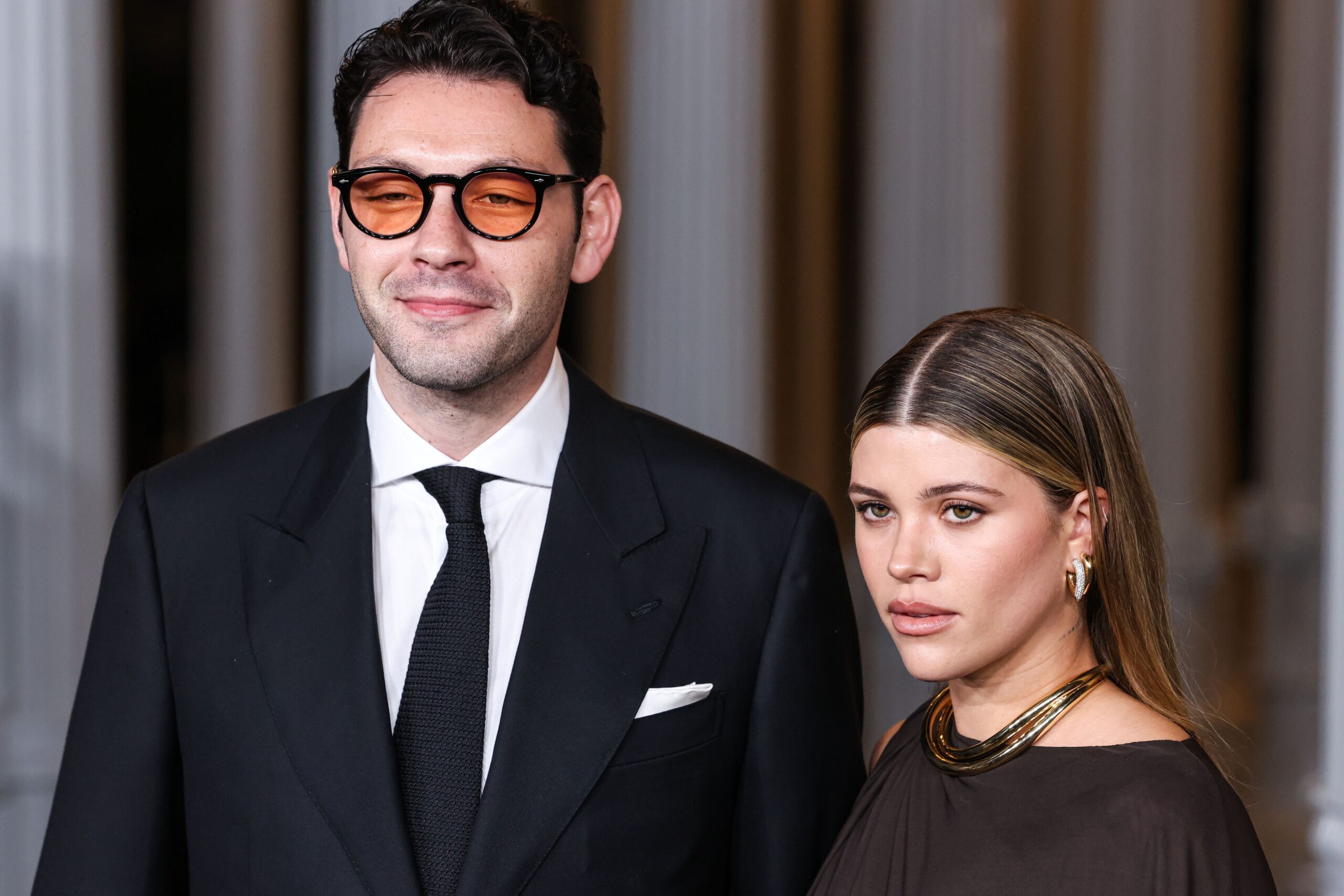 Sofia Richie posing alongside husband Elliot Grainge at event