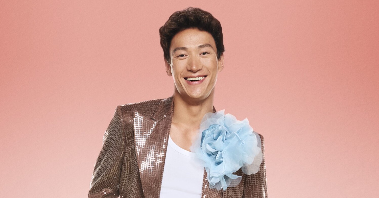 Carlos Gu posing in brown suit in Strictly press image