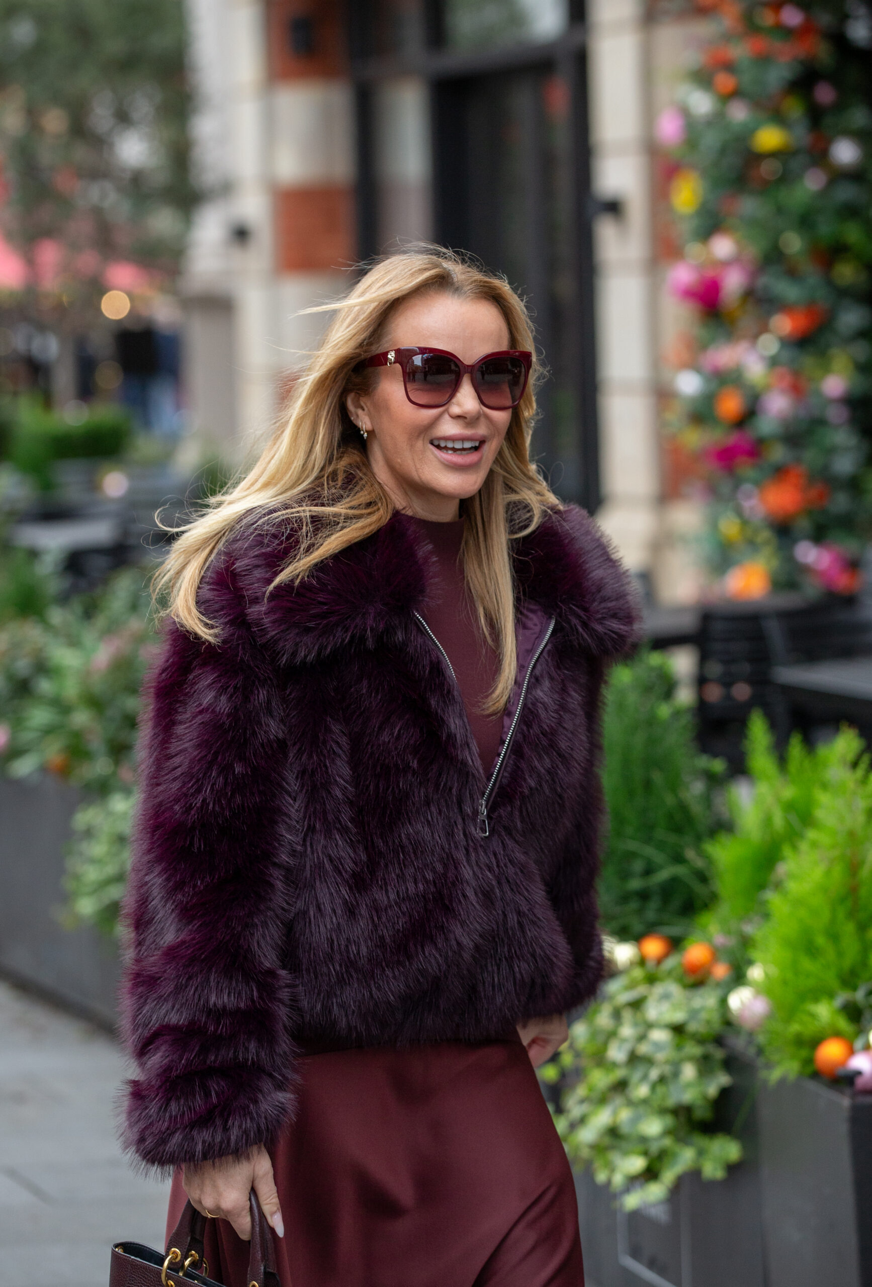 Amanda Holden smiling in a fur coat