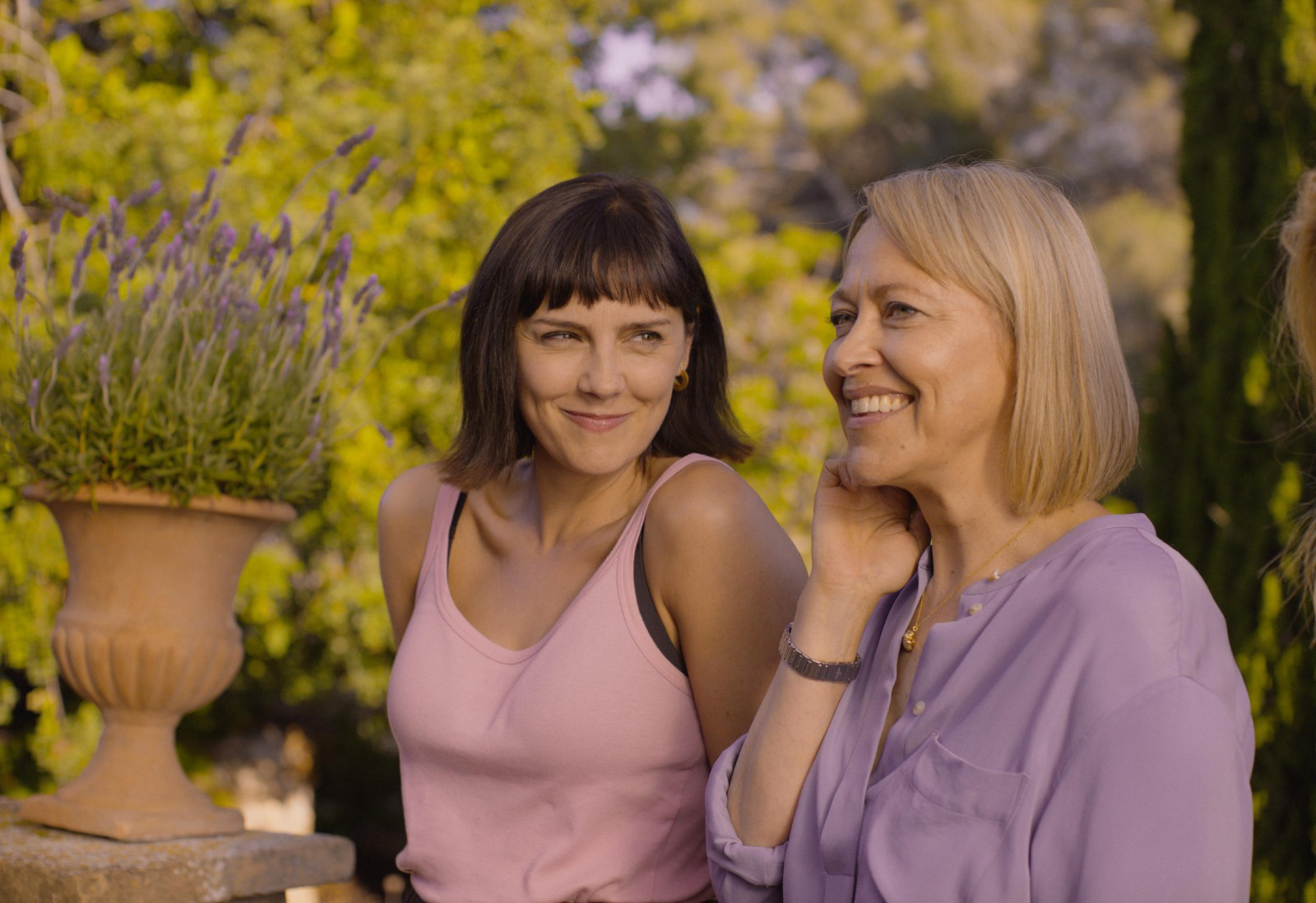Two sisters from The Sp;t smiling while speaking to each other