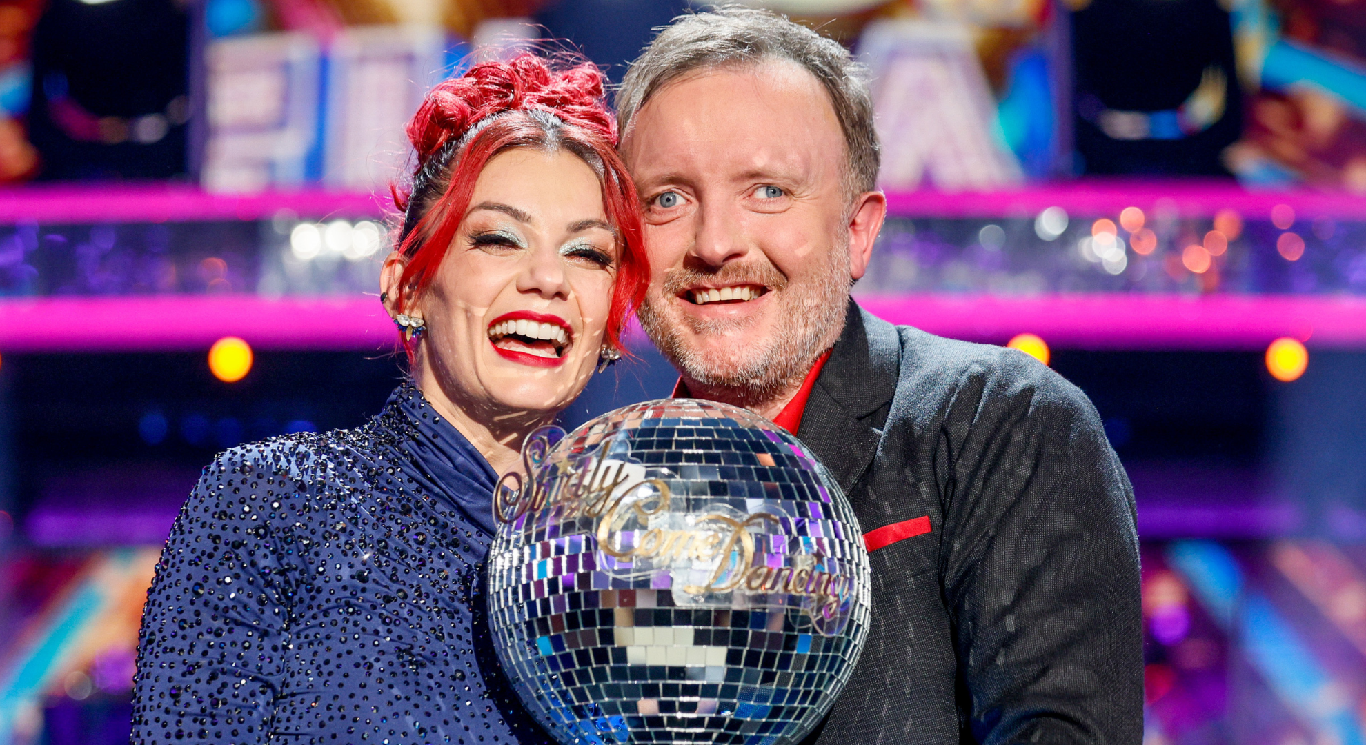 Dianne Buswell and Chris McCausland holding the Strictly trophy